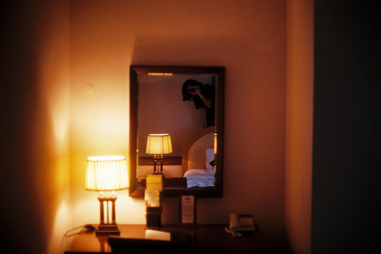 Self-portrait in a hotel room